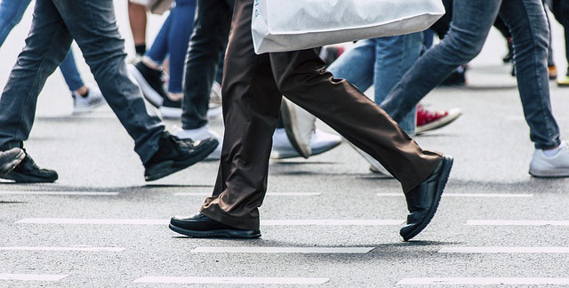 Pedestrians' legs walking on a street